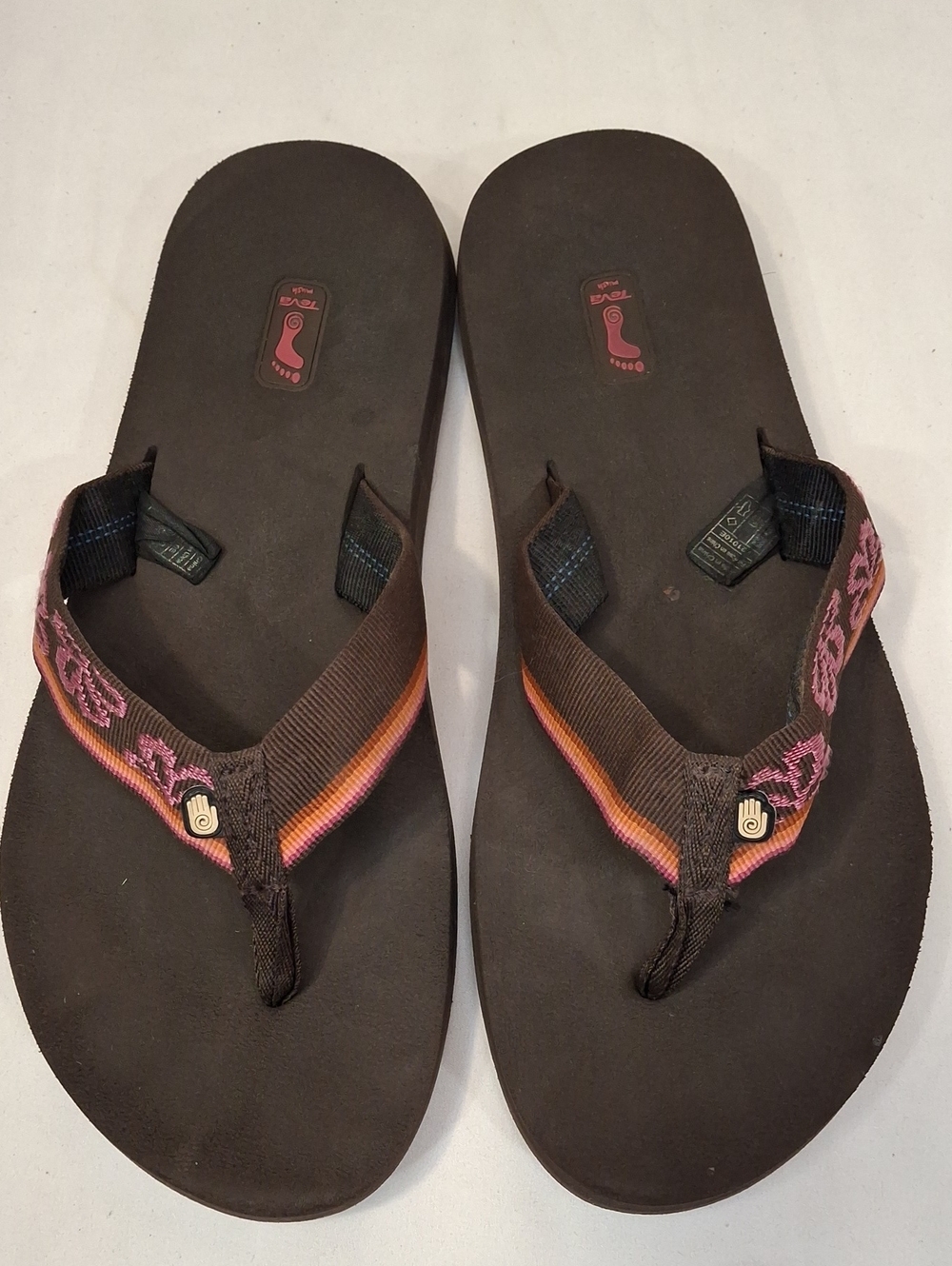 Teva Men's Brown Flip Flops with Mauve and Orange Accents.Lightly Worn